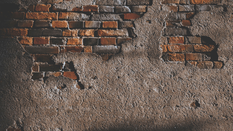 brick wall with crumbling concrete veneer